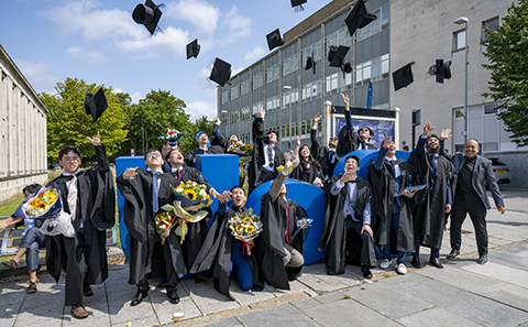 Group of people in hats and gowns